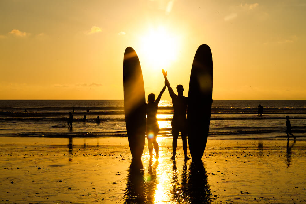 couple surfing bali